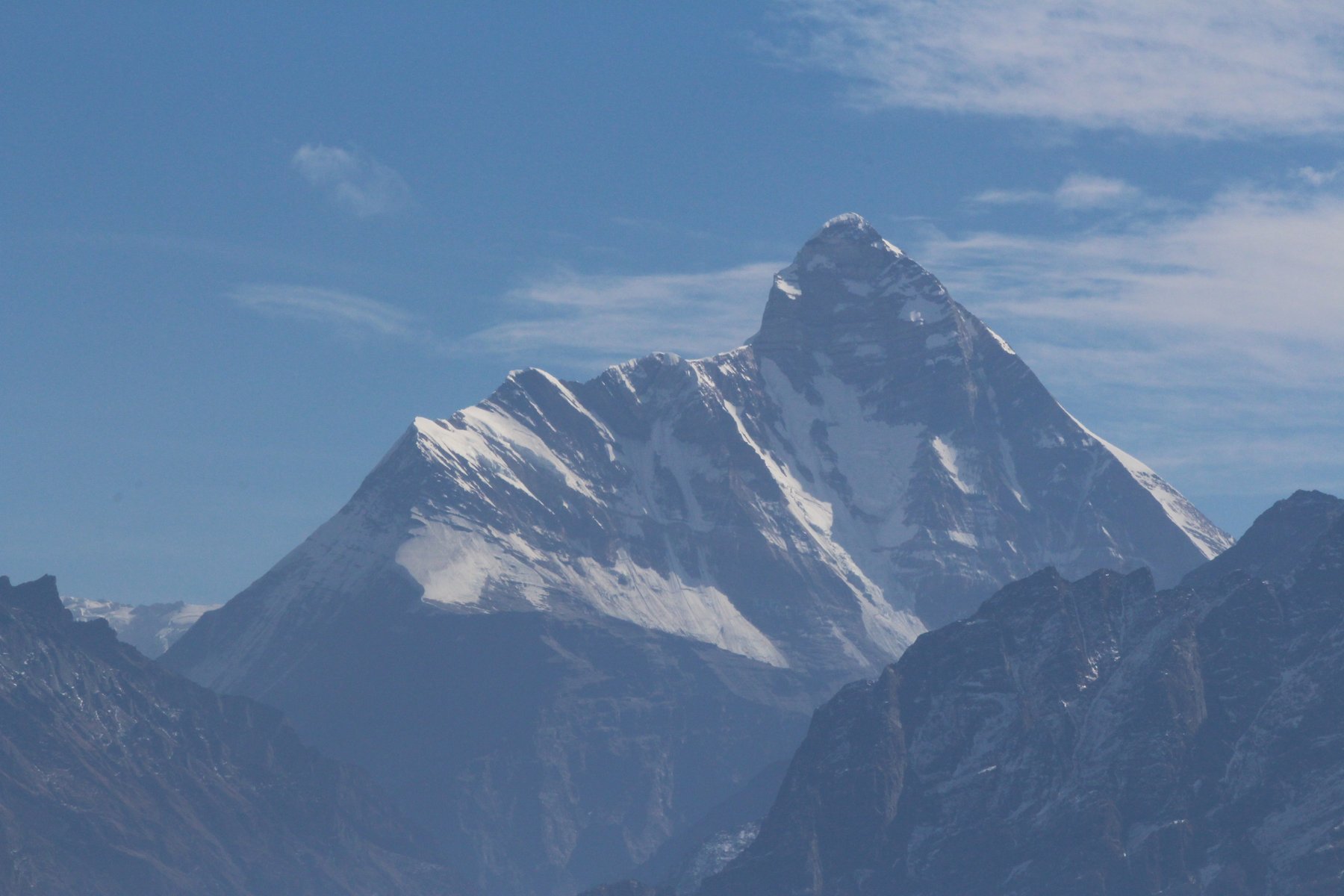 Nanda Devi, the twin-summited peak this trek circles toward, seen from Auli on the mountain's western side