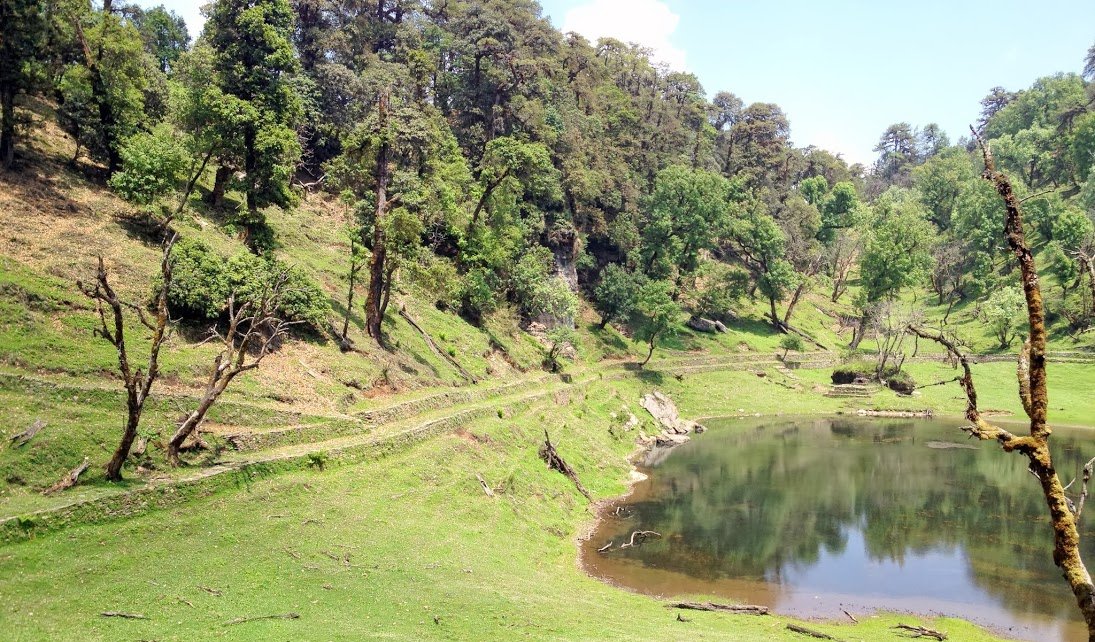 Thamri Kund, a still alpine lake ringed by oak and rhododendron forest near Harkot village, Munsiyari