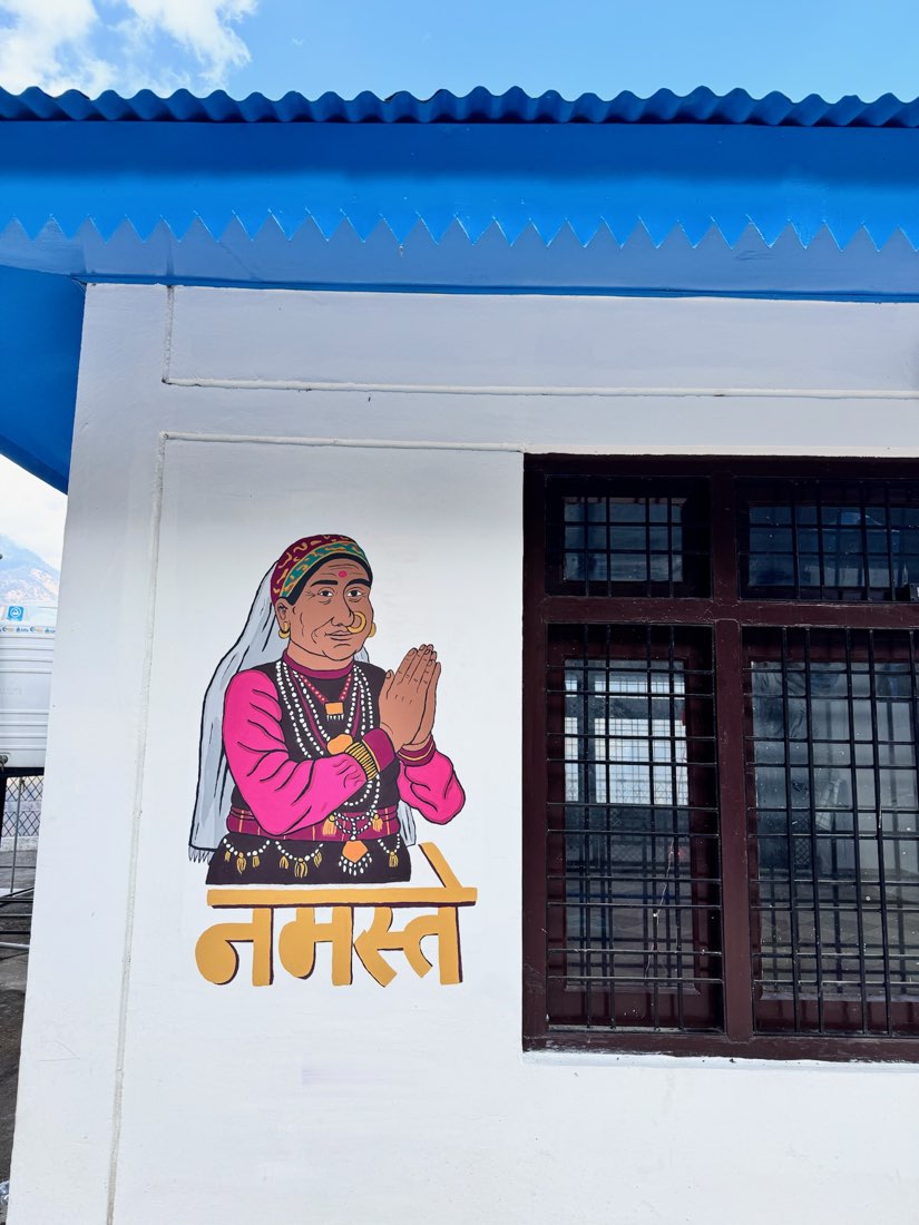 Hand-painted Namaste welcome mural at the entrance